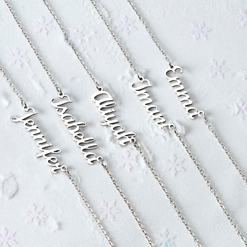 Several silver name necklaces on a white background | Chosen Name Necklace