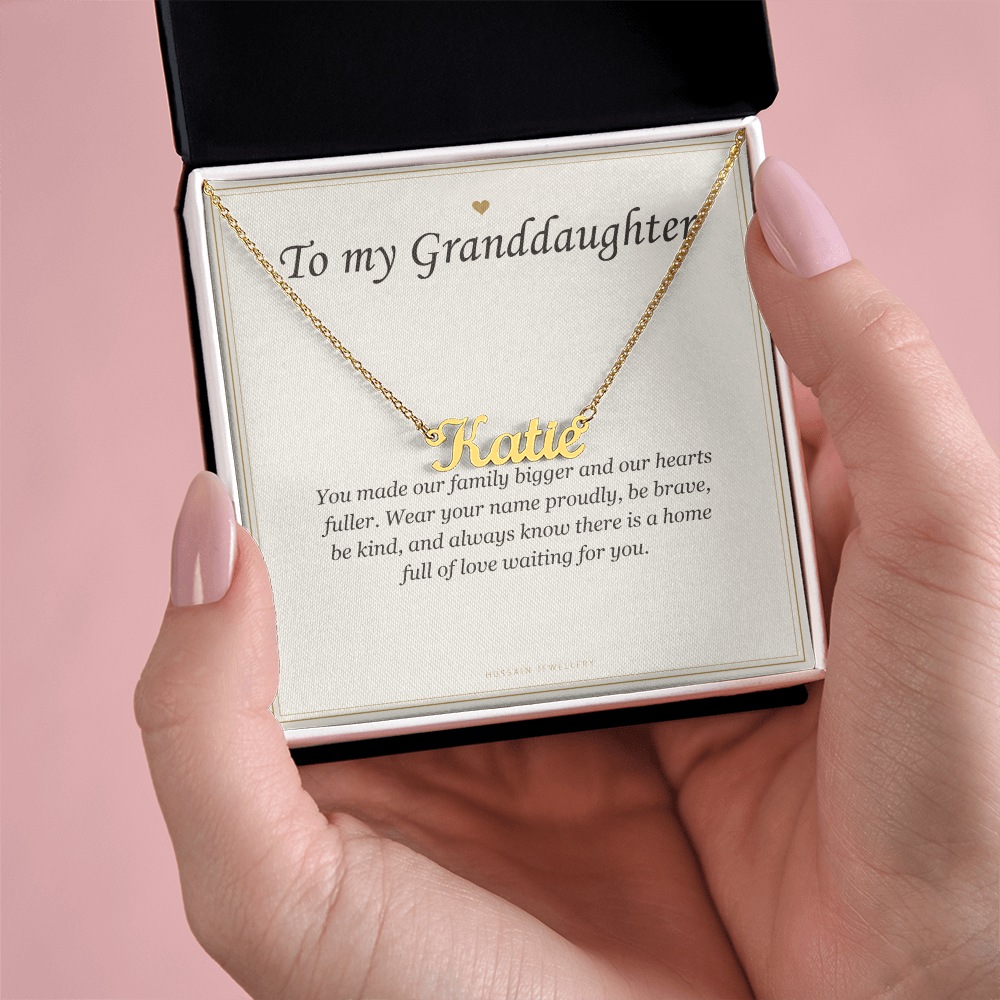 Hands holding the gold finish pendant and card over a pink background | Granddaughter Name Necklace with Message Card