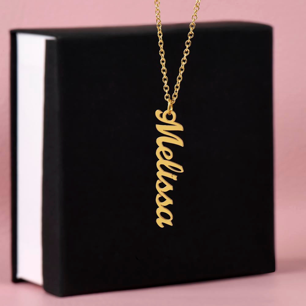 Gold finish vertical name pendant draped over a black gift box | Vertical Name Necklace