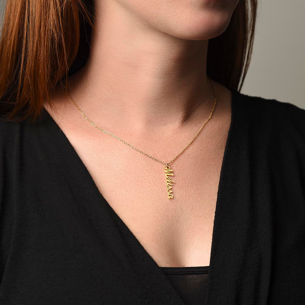 Gold finish vertical name necklace worn with a V-neck top | Vertical Name Necklace