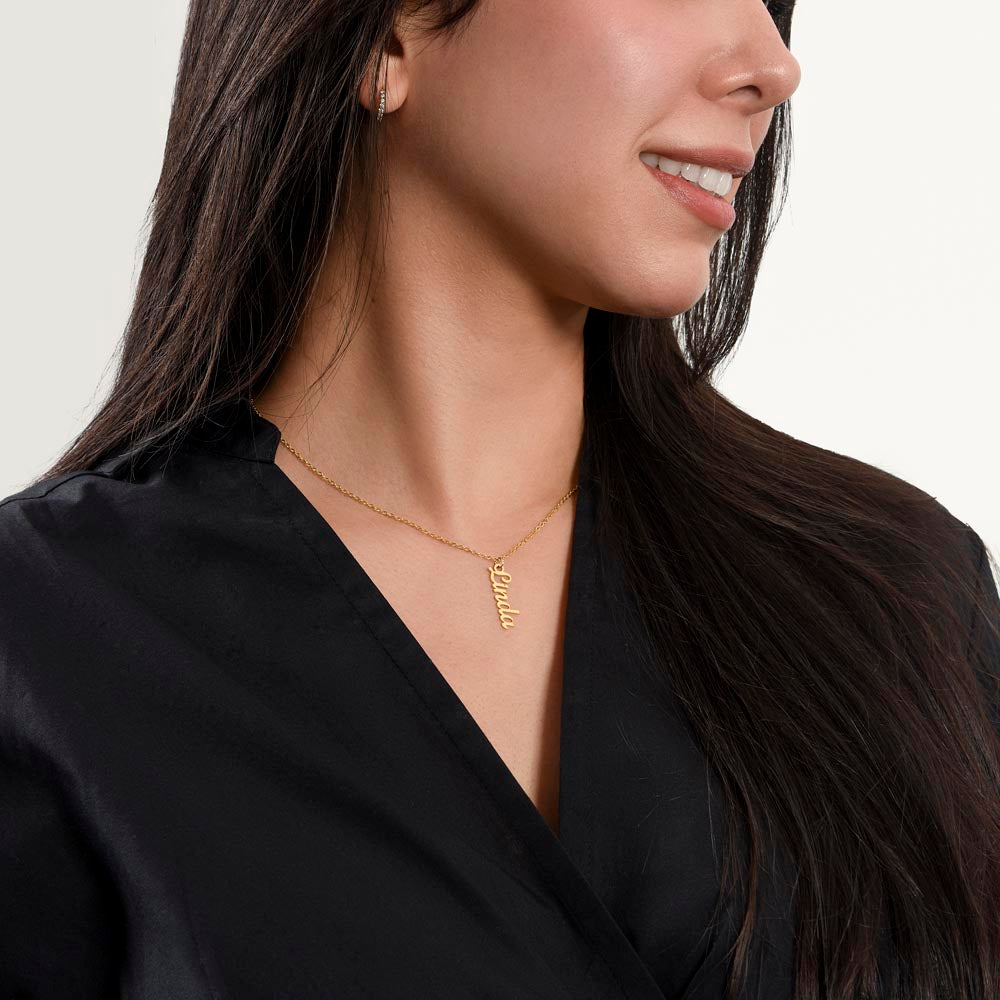 Smiling woman in black wearing the gold finish necklace | Vertical Name Necklace