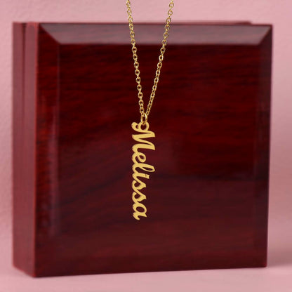 Gold finish vertical name pendant draped over the mahogany Luxury Box | Vertical Name Necklace