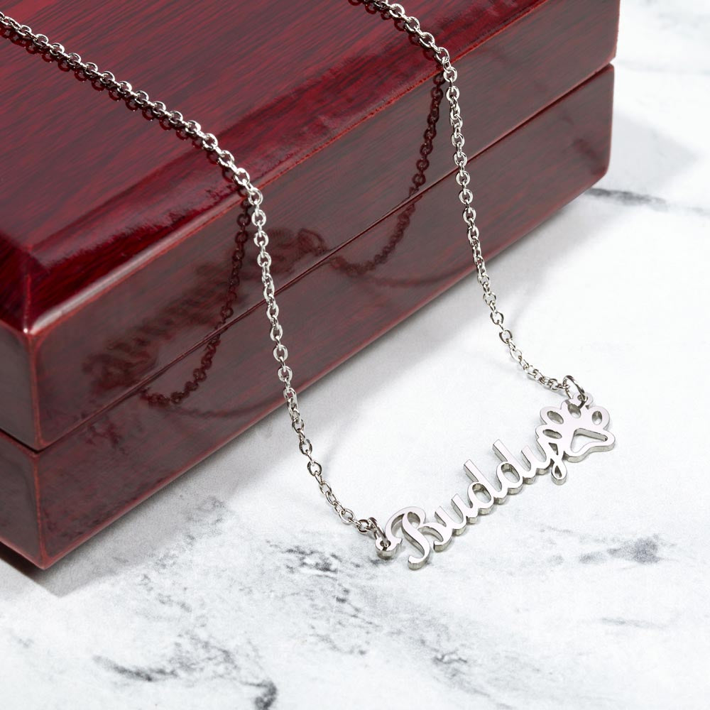 Steel paw print name necklace on a marble surface | Dog Mom Paw Print Name Necklace with Message Card