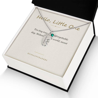 Silver charm and card in an open gift box | Baby Feet Birthstone Necklace