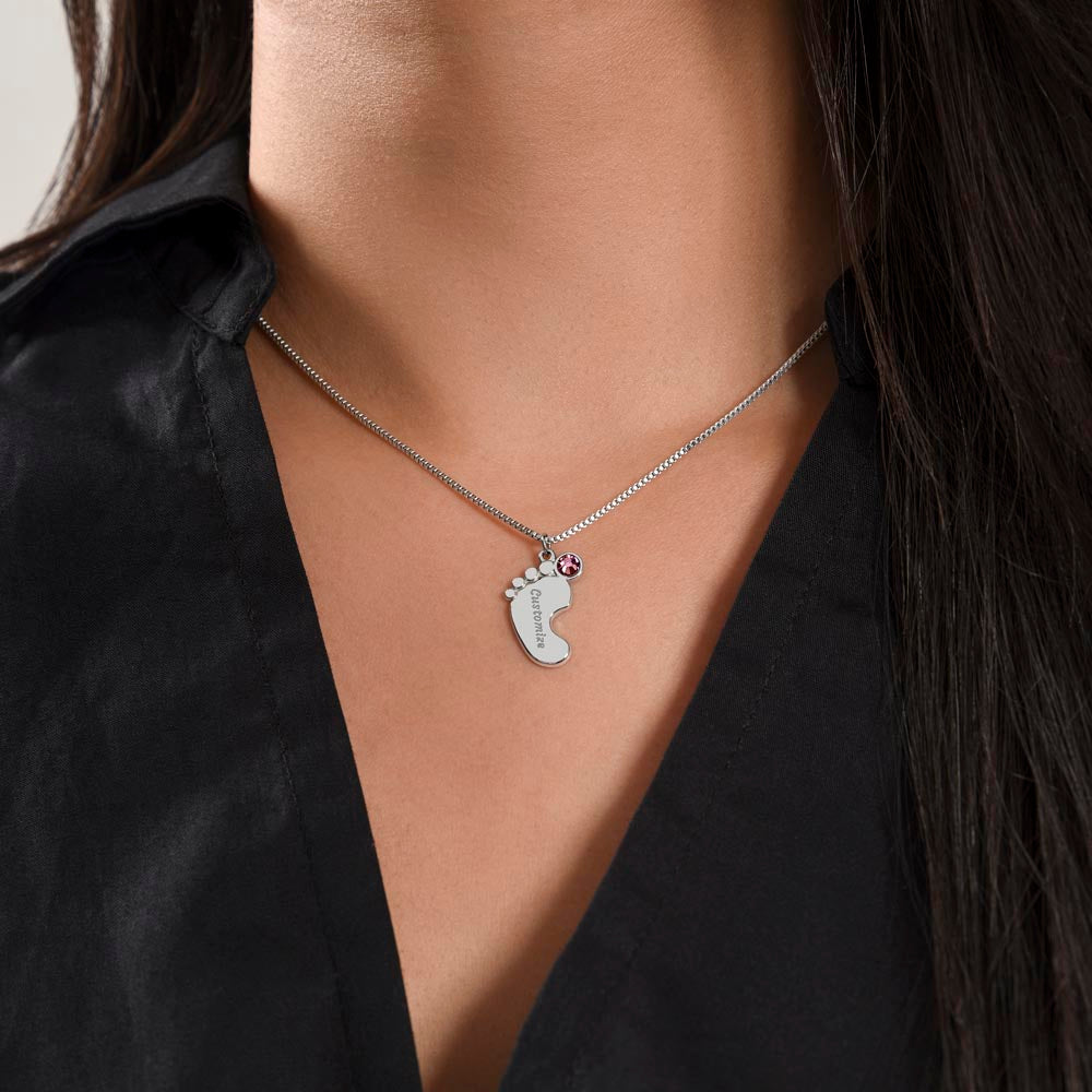 Silver baby feet necklace worn with a black top | Baby Feet Birthstone Necklace