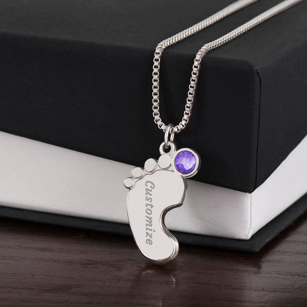 Silver baby feet pendant with a purple birthstone on a black gift box | Baby Feet Birthstone Necklace