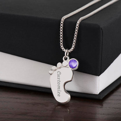 Silver baby feet pendant with a purple birthstone on a black gift box | Baby Feet Birthstone Necklace