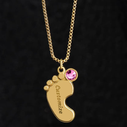 Gold finish baby feet pendant with a pink birthstone on black | Baby Feet Birthstone Necklace
