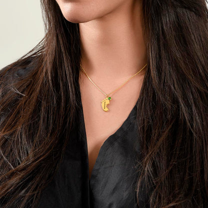 Gold finish baby feet necklace worn with a black top | Baby Feet Birthstone Necklace