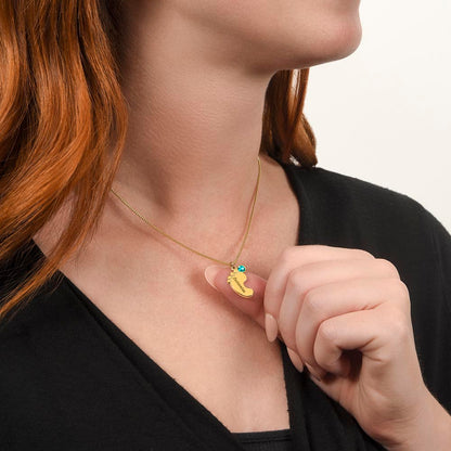Gold finish baby feet necklace worn, hand at the pendant | Baby Feet Birthstone Necklace