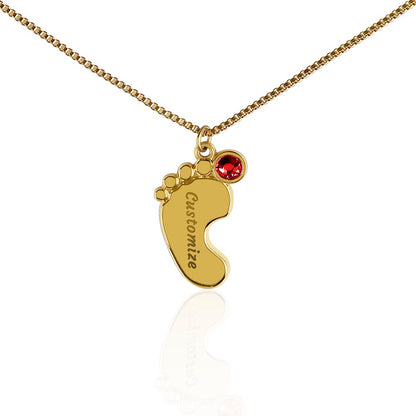 Gold finish baby feet pendant with a red birthstone on white | Baby Feet Birthstone Necklace