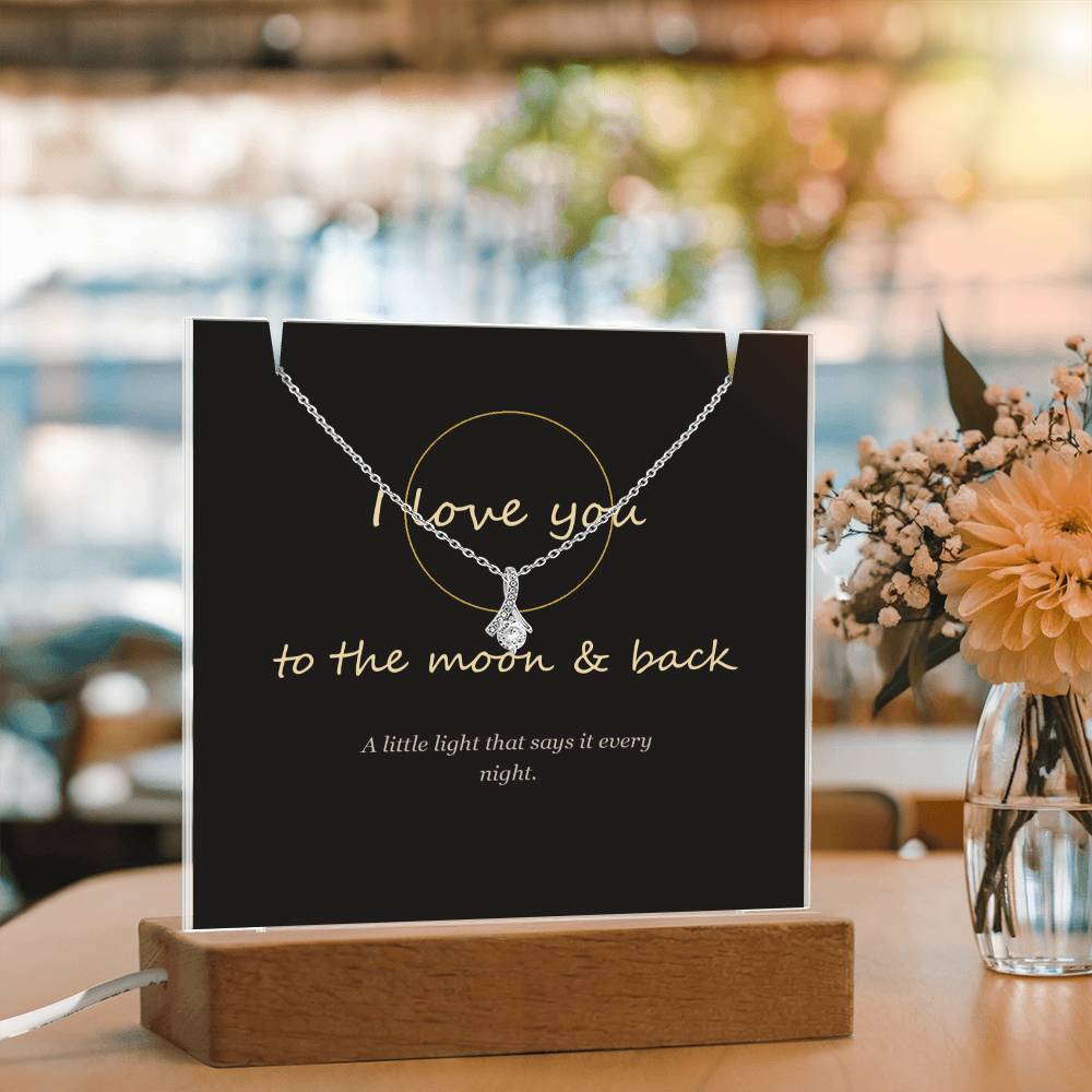 I love you to the moon and back keepsake light beside flowers | To the Moon & Back Keepsake Light & Necklace
