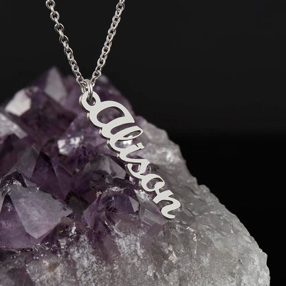 Silver vertical name pendant resting on an amethyst crystal | Stacked Vertical Names Necklace