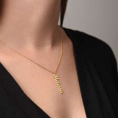 Gold finish vertical name necklace worn with a black top | Stacked Vertical Names Necklace