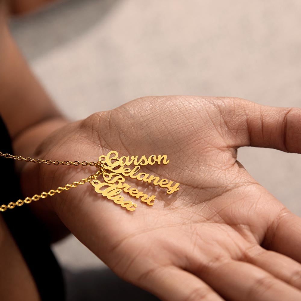 Four gold finish vertical names held in the palm | Stacked Vertical Names Necklace