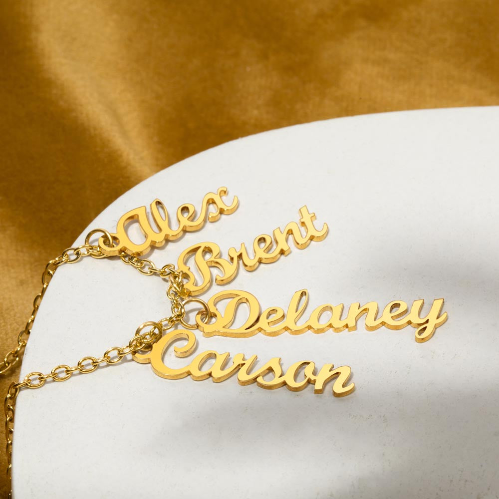 Four gold finish vertical names on a gold surface | Stacked Vertical Names Necklace
