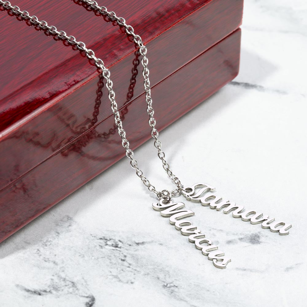Two silver vertical names on marble beside a gift box | Stacked Vertical Names Necklace