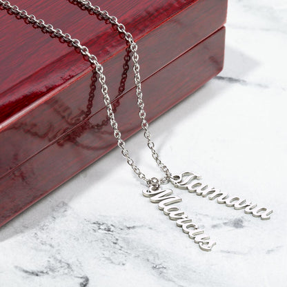 Two silver vertical names on marble beside a gift box | Stacked Vertical Names Necklace
