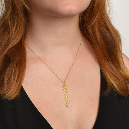 Gold finish birth flower name necklace worn with a black top | Flower Name Necklace