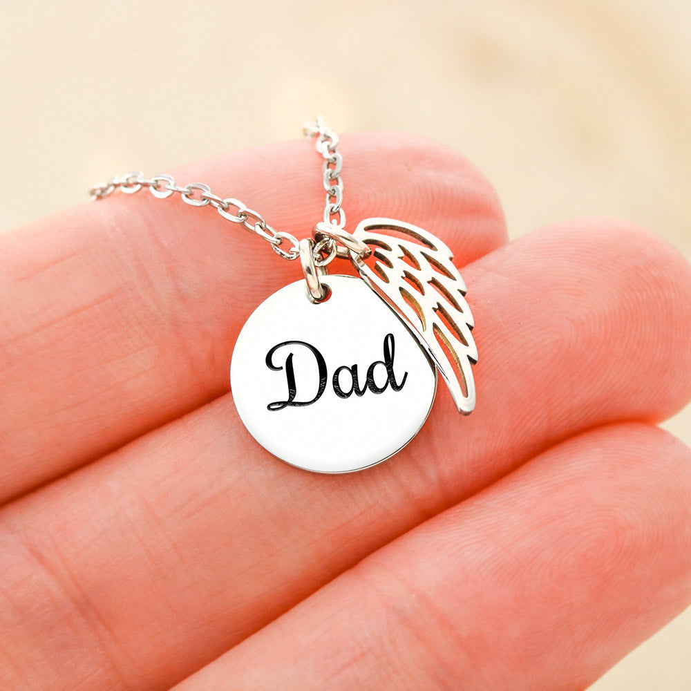 Silver Dad disc and angel wing charm held between the fingers | Memorial Necklace for Dad