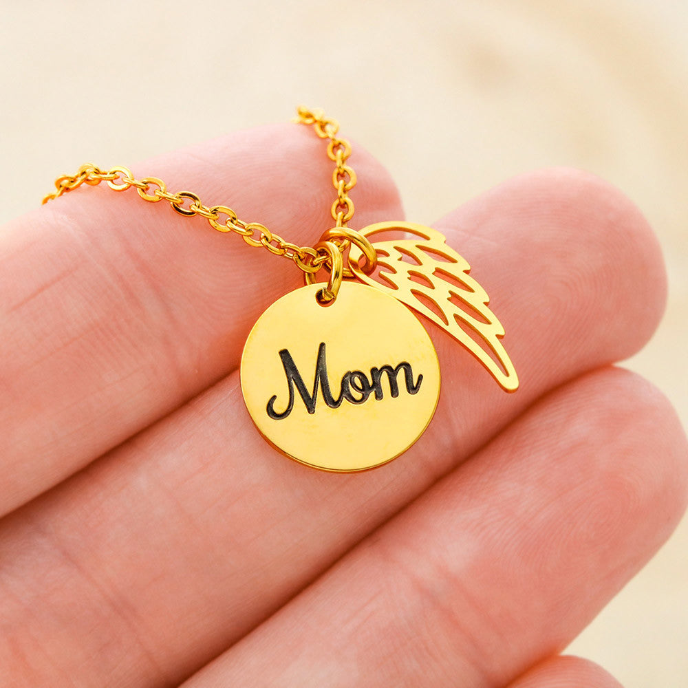 Gold finish Mom disc and wing charm held between the fingers | Memorial Necklace for Mom