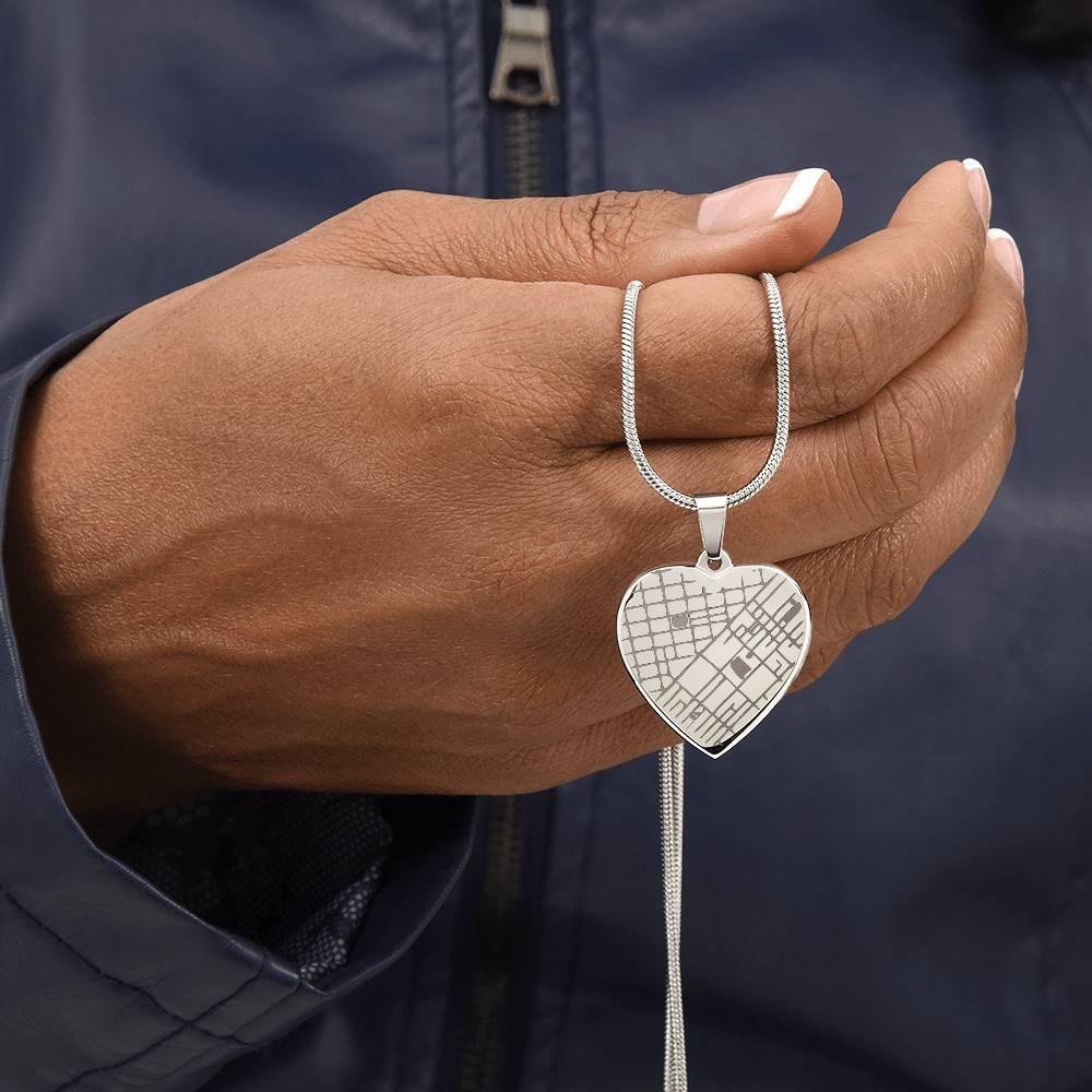 Hand holding the map heart necklace by its chain | Engraved Coordinates Heart Necklace