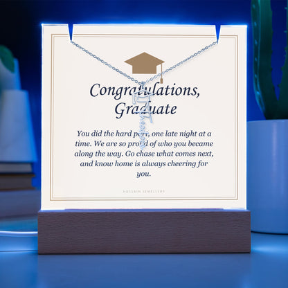 Graduate keepsake glowing blue on its LED base, with the name necklace | Graduation Cap Name Necklace and Keepsake Light