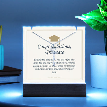 Graduate keepsake glowing blue on a desk, with the name necklace | Graduation Cap Name Necklace and Keepsake Light