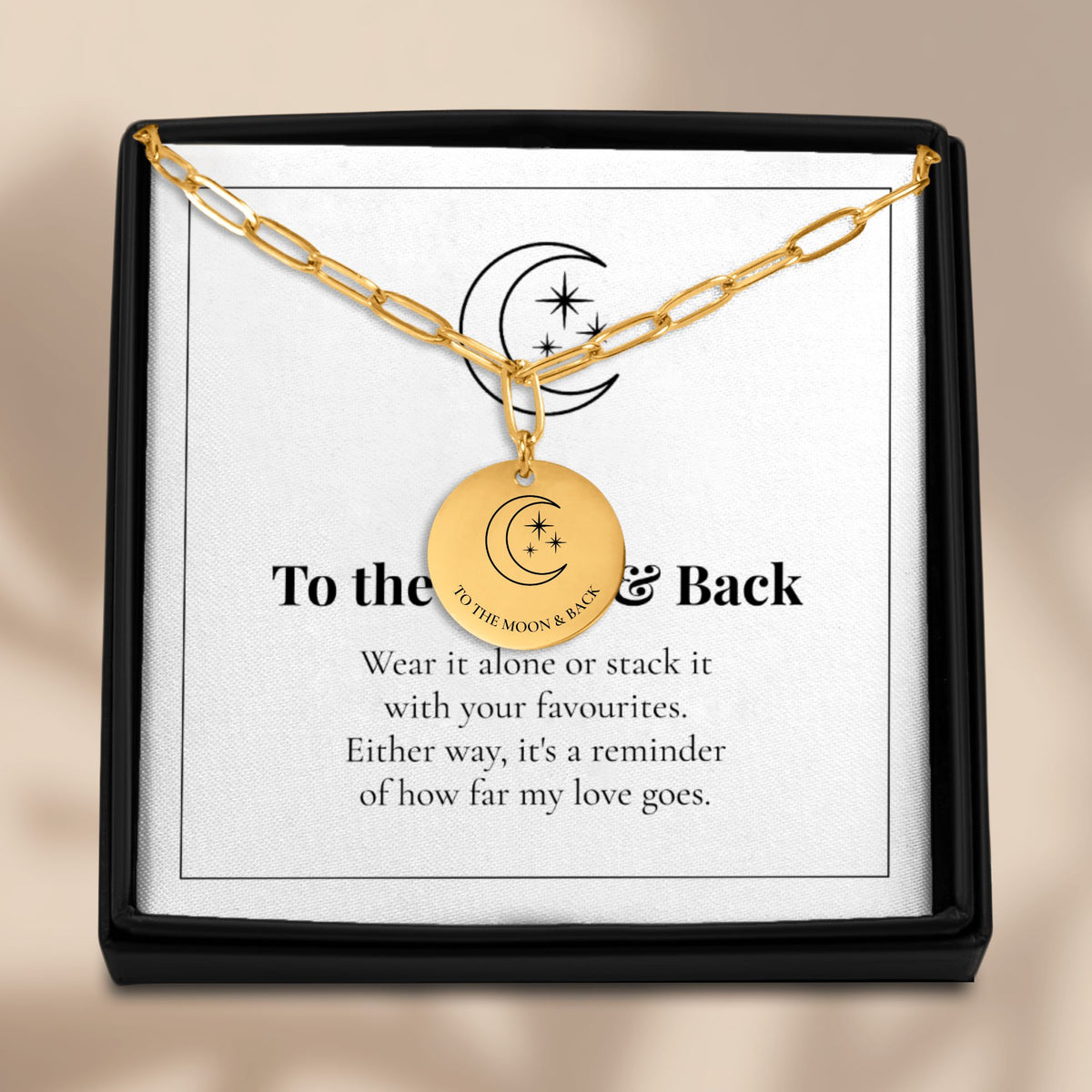 To the Moon and Back necklace displayed on its card in a black gift box