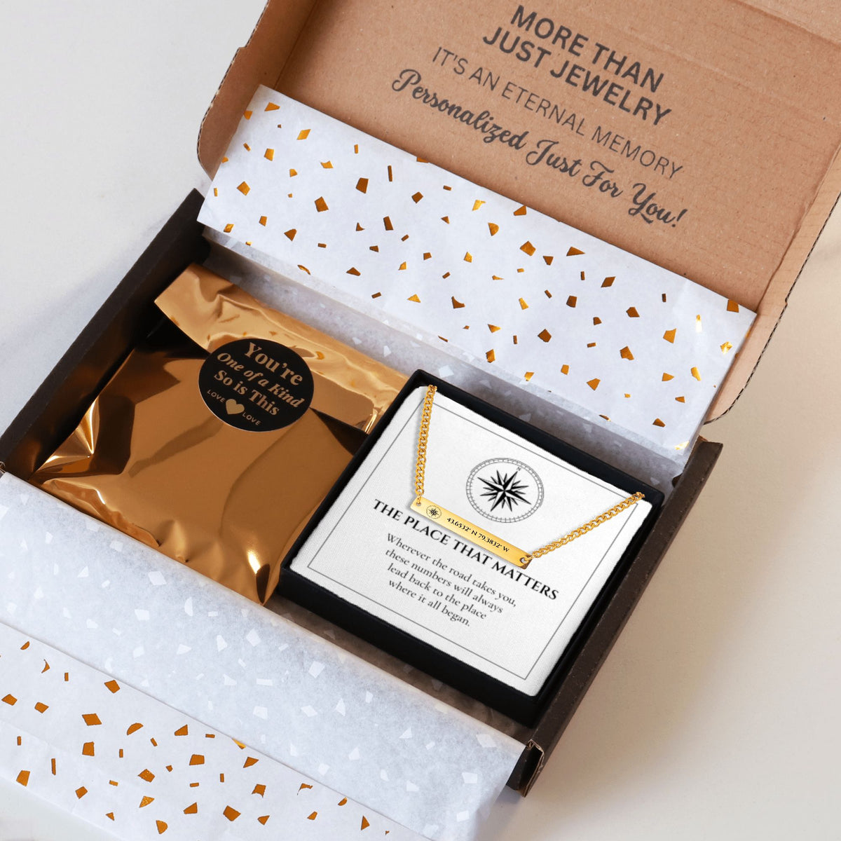 Coordinates bar necklace packed in a kraft shipping box with tissue