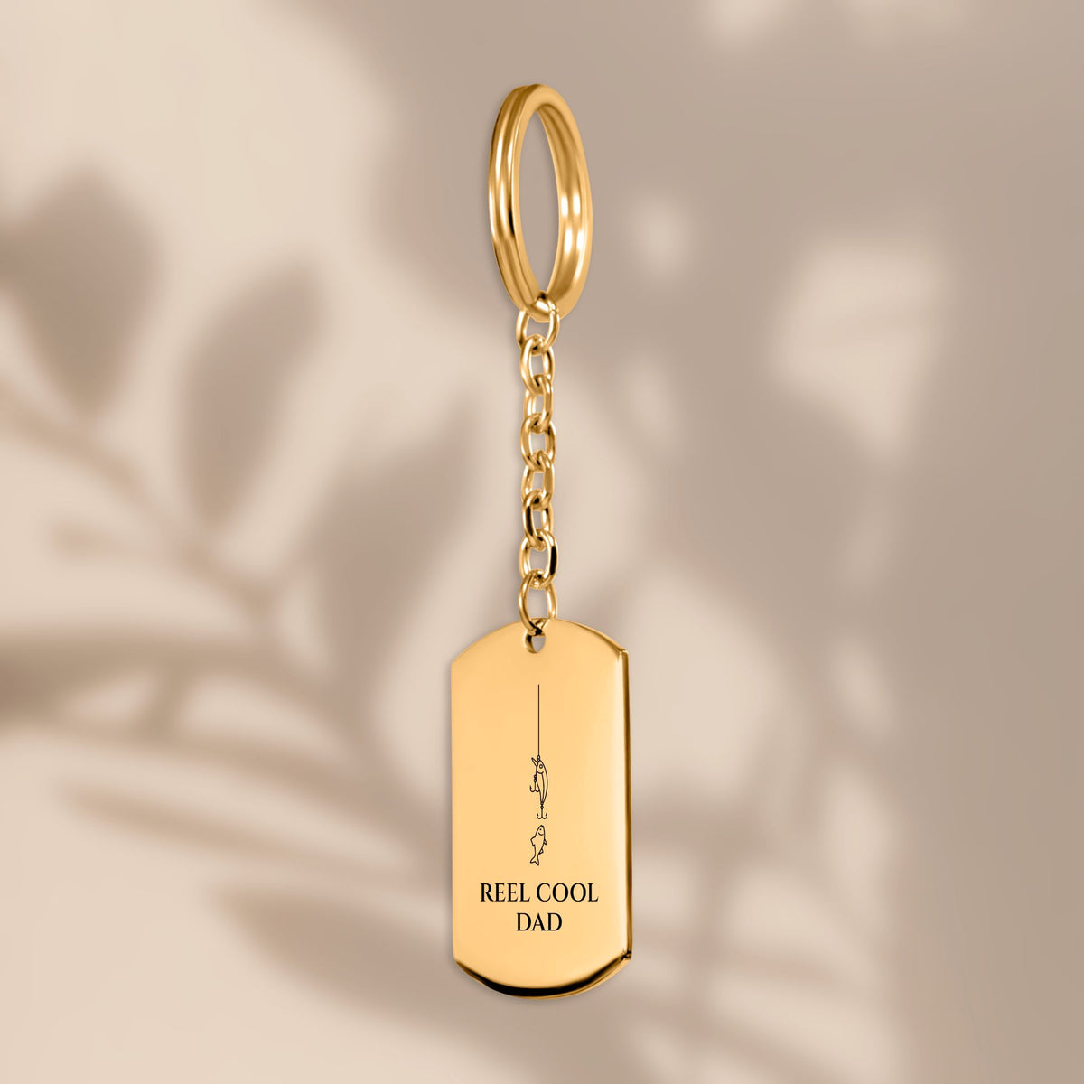Reel Cool Dad fishing tag keychain in soft window light