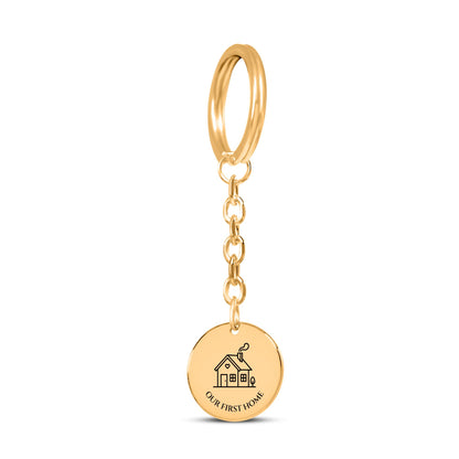 Gold plated coin keychain engraved with a house and OUR FIRST HOME