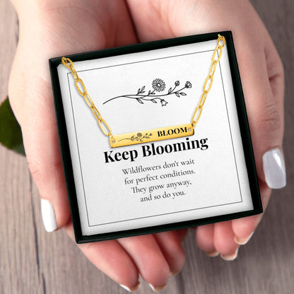 Hands holding the Bloom necklace gift box