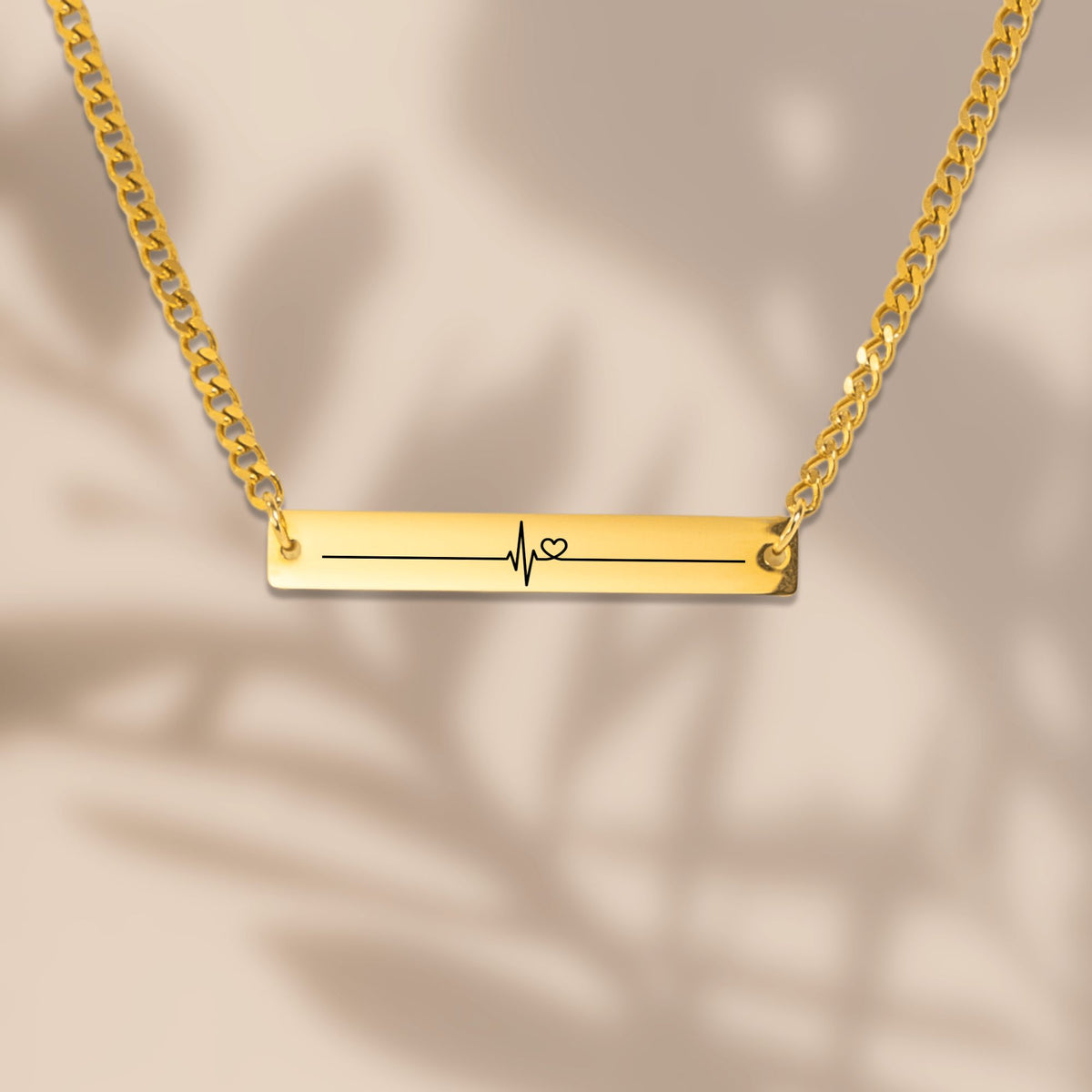 Close-up of the laser engraved heartbeat bar on a Cuban chain