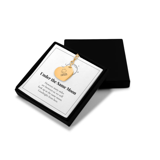 Under the Same Moon heart keychain in an open gift box with message card