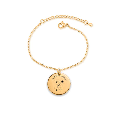 Chain bracelet with a round coin charm engraved with the Orion constellation and KEEP LOOKING UP