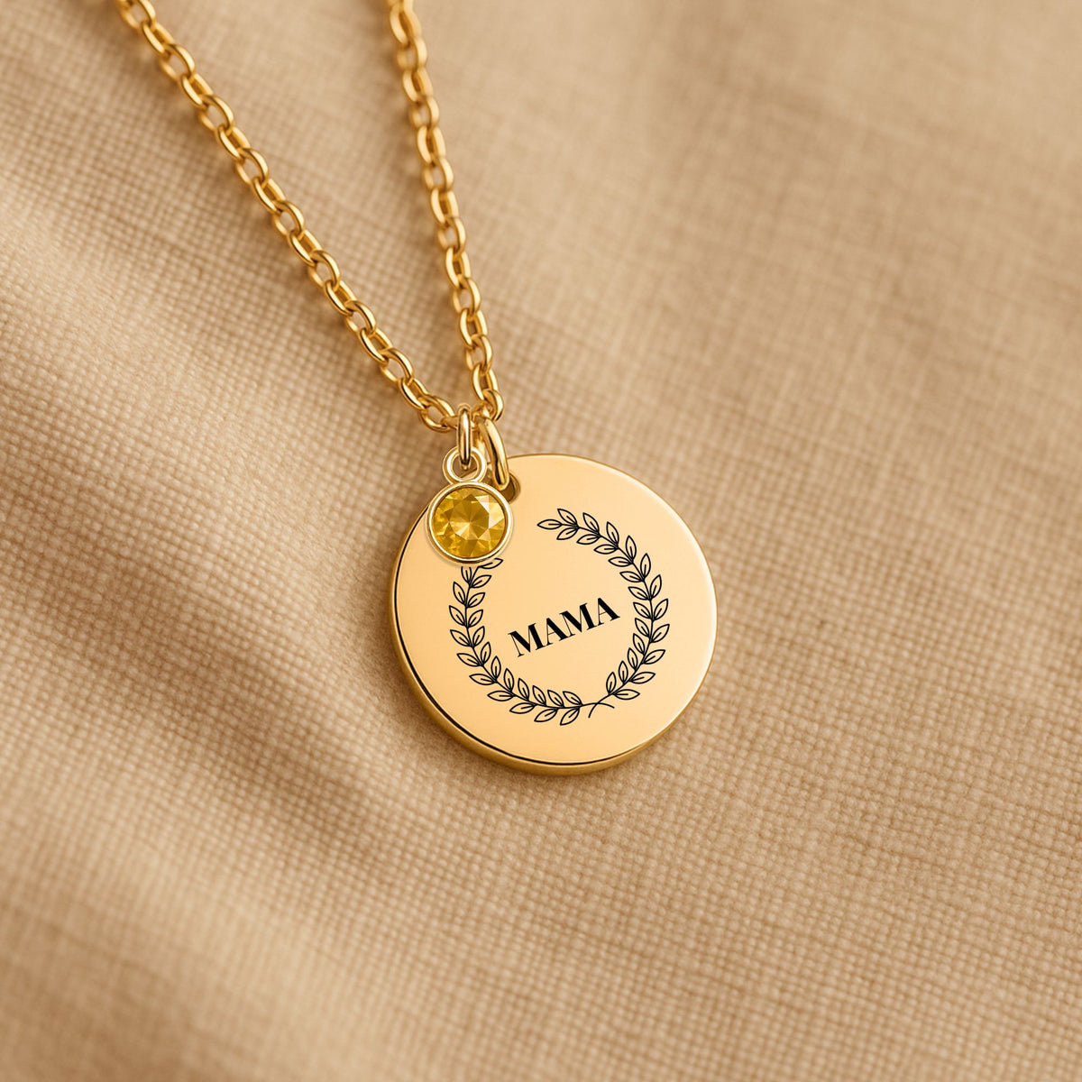 Laurel wreath MAMA coin necklace with a birthstone charm on linen