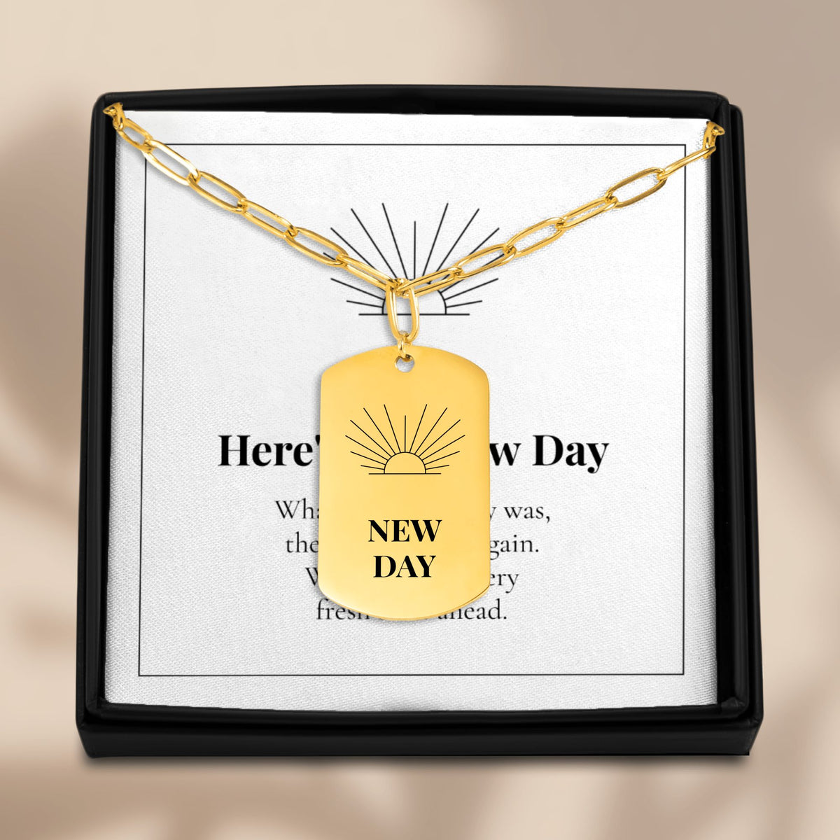 New Day necklace on its message card in a black gift box