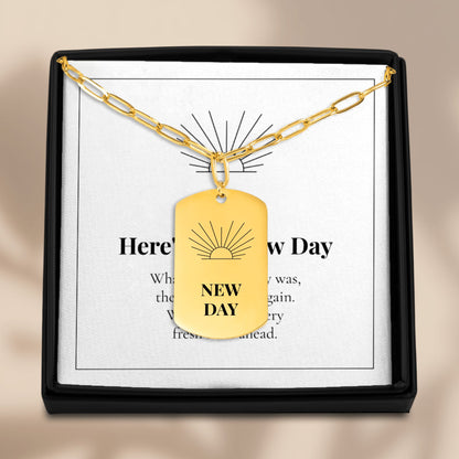 New Day necklace on its message card in a black gift box