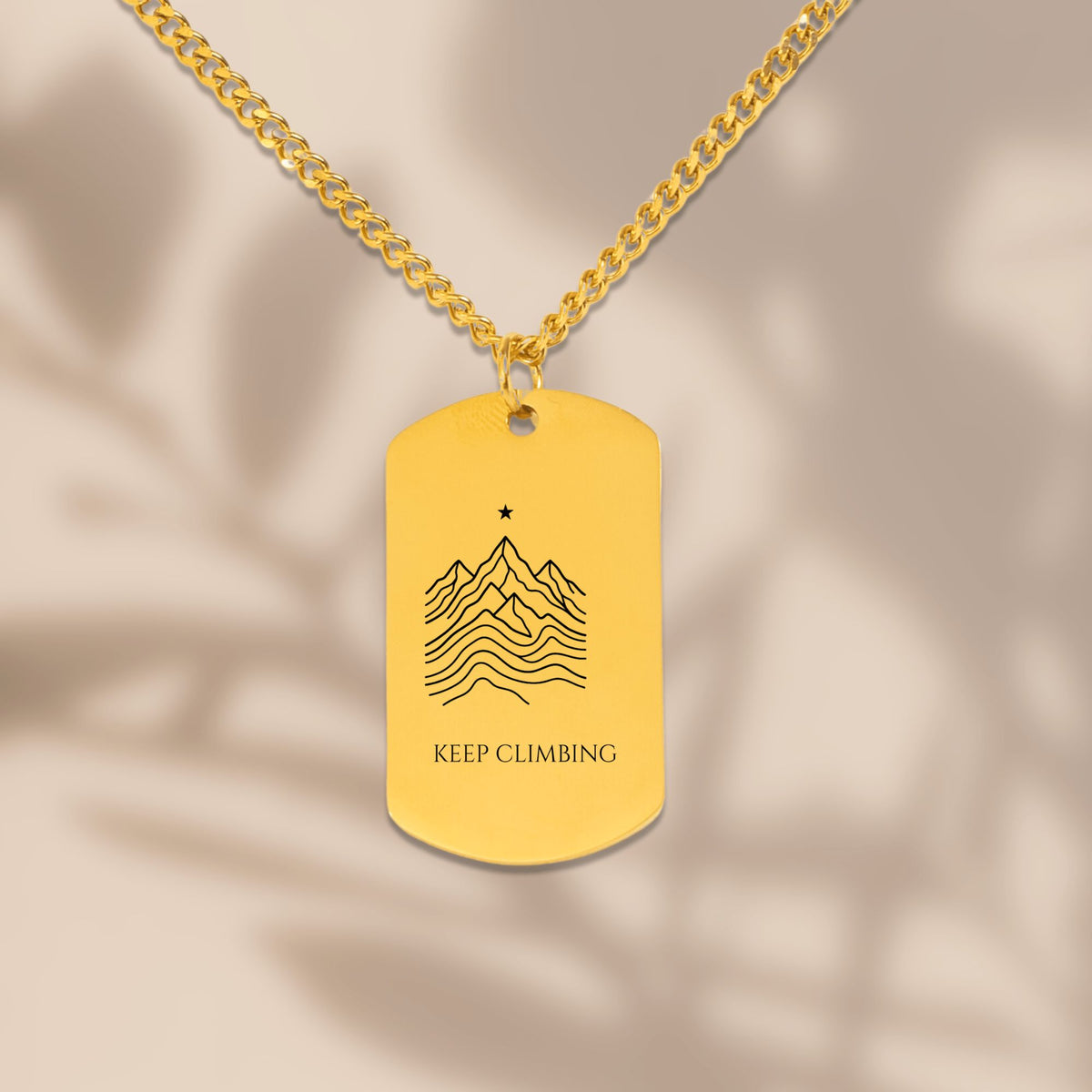 Close-up of the laser engraved mountain ridge dog tag on a Cuban chain