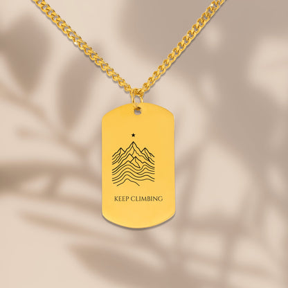 Close-up of the laser engraved mountain ridge dog tag on a Cuban chain
