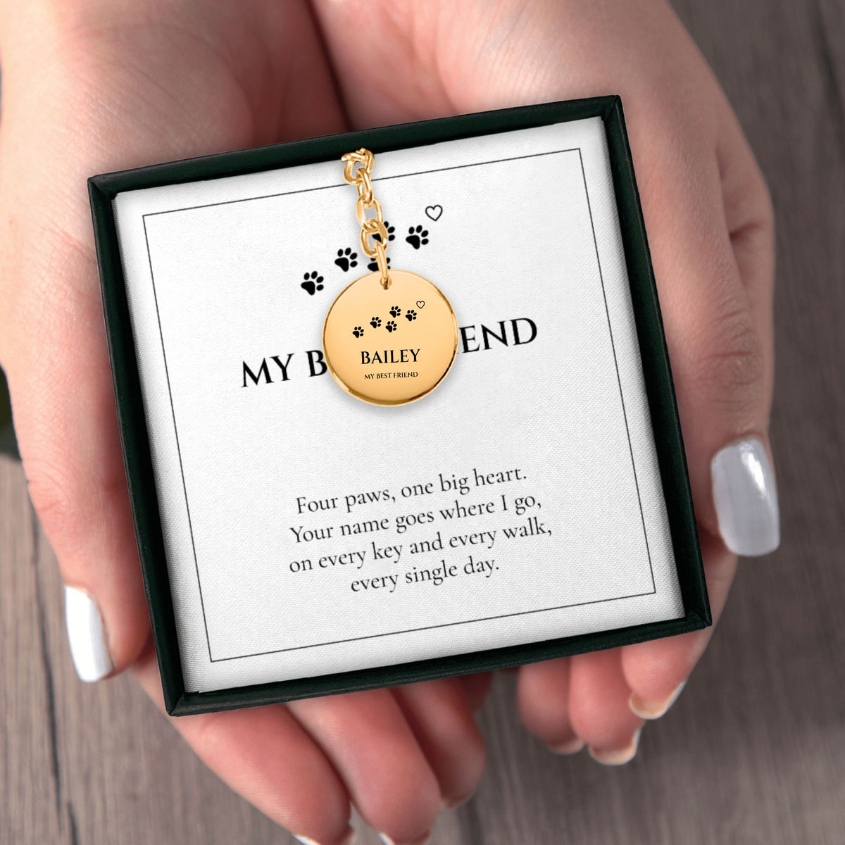 Hands holding the MY BEST FRIEND pet name keychain gift box