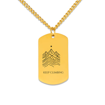 Mountain ridge and KEEP CLIMBING engraving on a dog tag pendant, front view