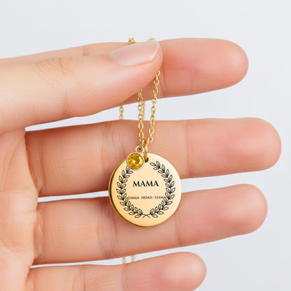 Mama birthstone coin necklace held between fingers