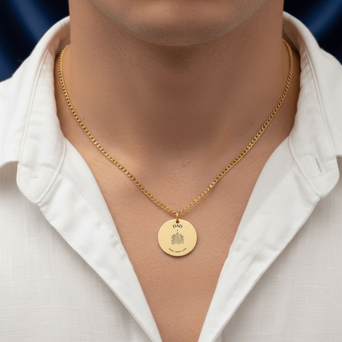 Dad coin necklace with kids' names worn with an open white shirt