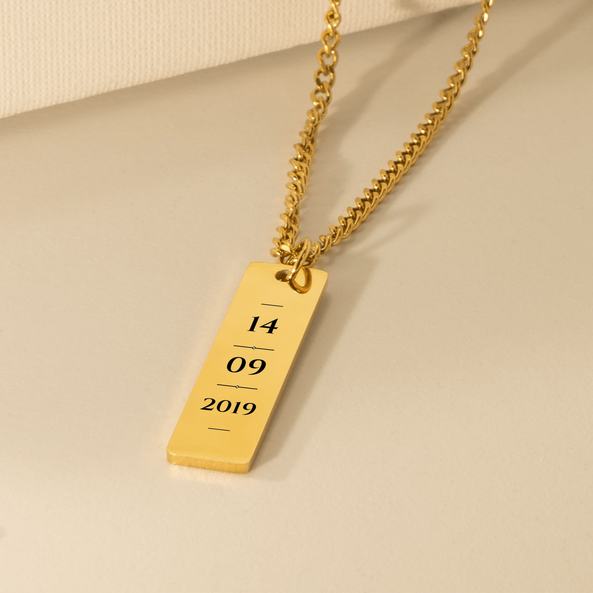 Gold vertical bar engraved with a sample date, 14 09 2019, on a Cuban chain