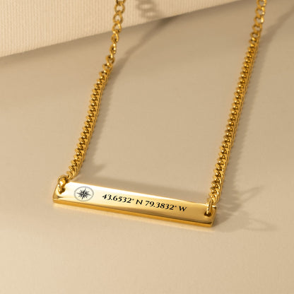 Gold Cuban chain bar engraved with a compass rose and sample map coordinates
