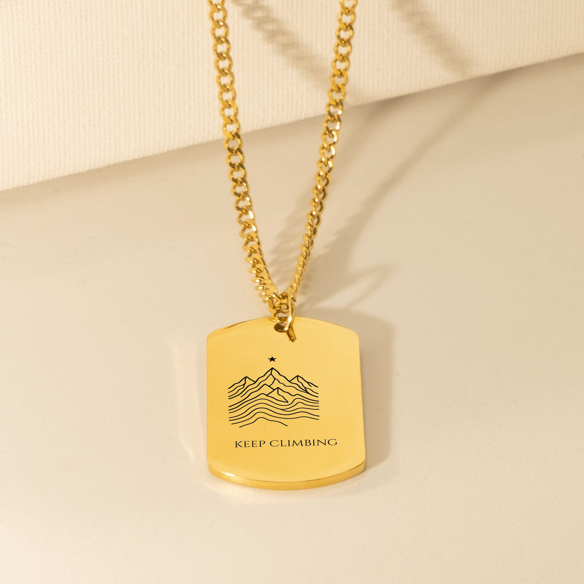 Engraved mountain ridge dog tag necklace on a Cuban curb chain, 18k gold plated