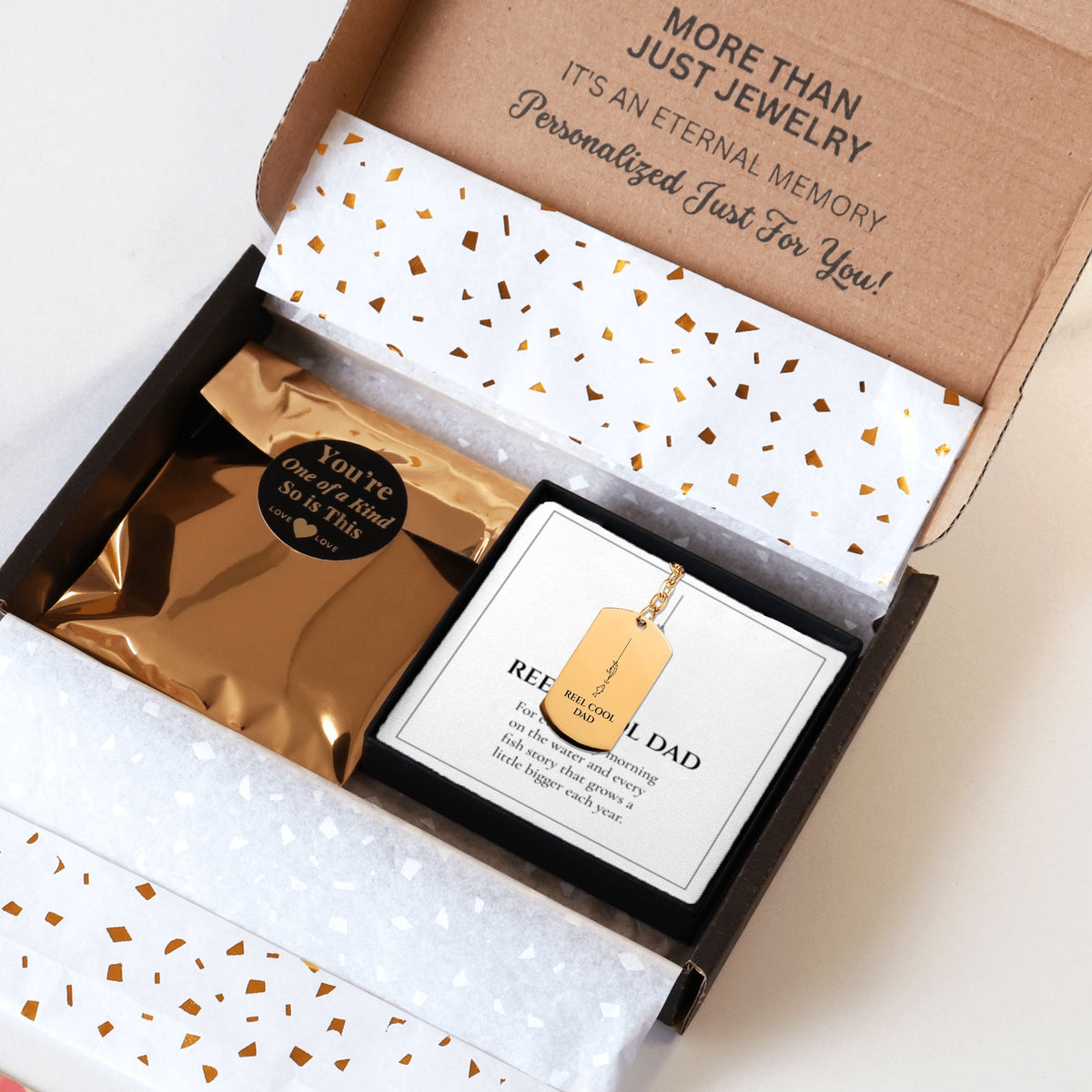 Reel Cool Dad keychain packed in a kraft shipping box with tissue