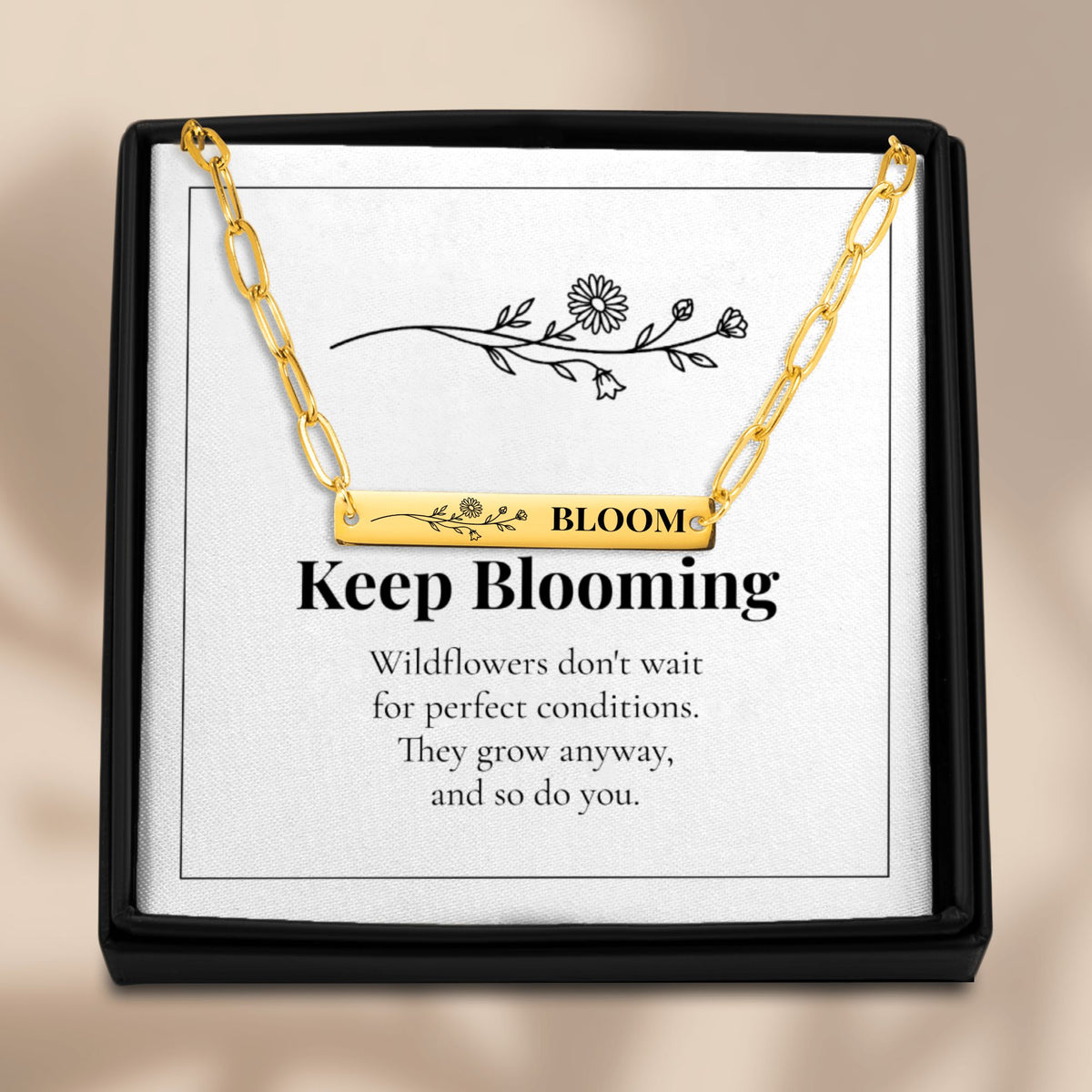 Bloom necklace on its Keep Blooming card in a black gift box